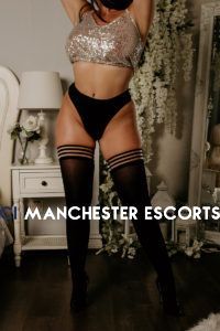 Holly stood up wearing a gold skimpy top with black knickers and stockings